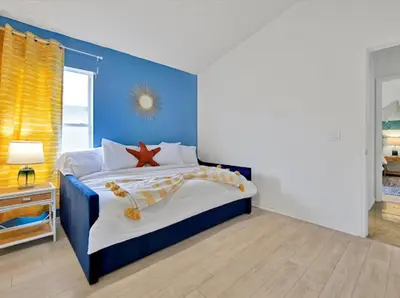 a blue bedroom with a bed with a starfish on it at 6BD - Pool, BBQ & Movie Theater - 10 Mins to Disney in Kissimmee