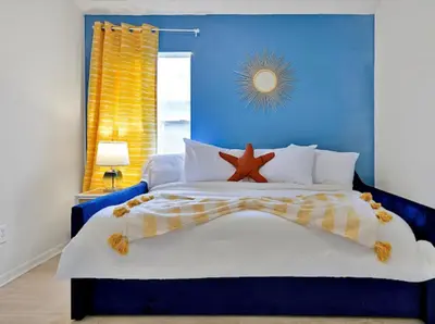 a blue bedroom with a bed with a starfish on it at 6BD - Pool, BBQ & Movie Theater - 10 Mins to Disney in Kissimmee