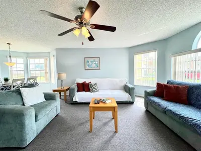 a living room with two couches and a ceiling fan at 2492 Your home away from Home in Kissimmee