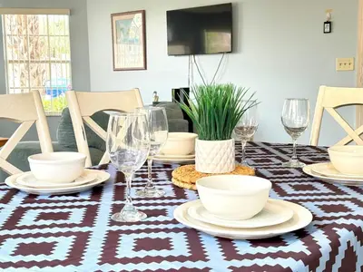 a table with wine glasses and plates on it at 2492 Your home away from Home in Kissimmee
