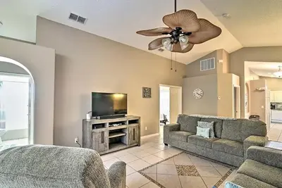 a living room with a couch and a flat screen tv at 4 Bed Villa in Kissimmee, Orlando in Kissimmee