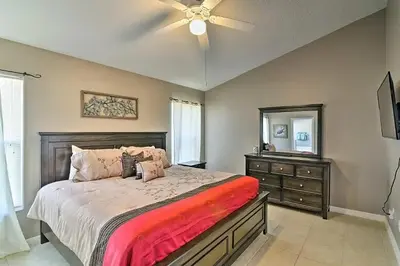 a bedroom with a bed with a ceiling fan and a dresser at 4 Bed Villa in Kissimmee, Orlando in Kissimmee