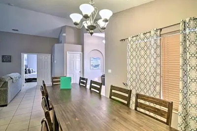 a dining room with a large wooden table and chairs at 4 Bed Villa in Kissimmee, Orlando in Kissimmee