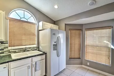 a kitchen with a white refrigerator and a sink at 4 Bed Villa in Kissimmee, Orlando in Kissimmee