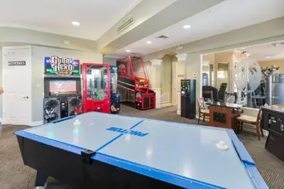 a pool table in a room with arcade games at Condo in Gated Windsor Hills in Orlando