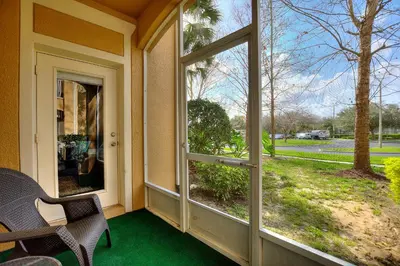 a porch with a large window with a view of a yard at Condo in Gated Windsor Hills in Orlando