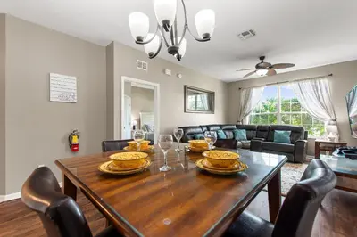 a dining room with a wooden table and chairs at Condo in Gated Windsor Hills in Orlando