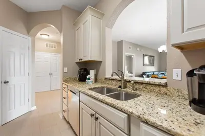 a kitchen with a sink and a counter top at Condo in Gated Windsor Hills in Orlando