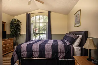 a bedroom with a bed and a window at 4 Bed Villa - Eagle Pointe - Kissimmee in Kissimmee
