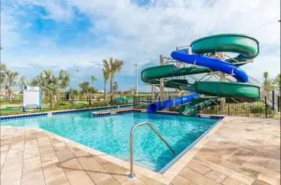 a water slide in a pool at a resort at Bright and Modern 4BR Home,Pool,Slides,By Disney in Kissimmee