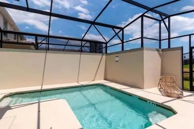 a swimming pool in a house with a glass ceiling at Bright and Modern 4BR Home,Pool,Slides,By Disney in Kissimmee