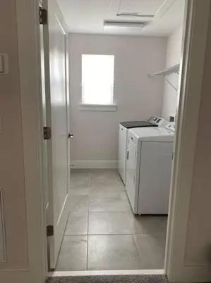 a white kitchen with a counter and a window at beautiful home in Kissimmee