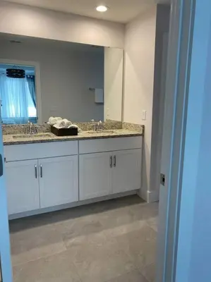 a bathroom with a sink and a large mirror at beautiful home in Kissimmee