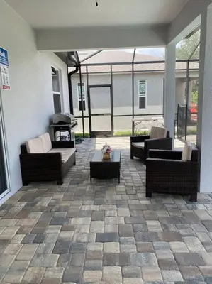 a patio with couches and a table on a patio at beautiful home in Kissimmee