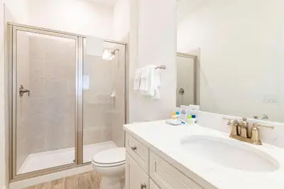 a bathroom with a shower and a toilet and a sink at Paradise Cottage Near Disney With Margaritaville Resort & Island H2O Access - 8052Dr in Orlando