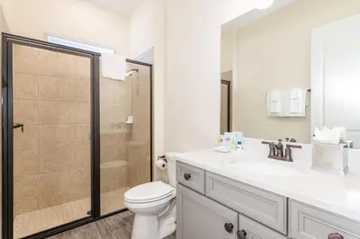 a bathroom with a toilet and a sink and a shower at Pleasant Cottage Near Disney With Margaritaville Resort & Island H20 Waterpark Access - 2972Sr in Orlando