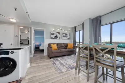 a kitchen and living room with a table and a couch at Apartment in Florida near Universal and Intern. Dr in Orlando