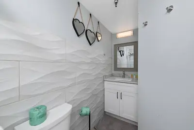 a white bathroom with a tub and a sink at Apartment in Florida near Universal and Intern. Dr in Orlando