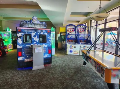 a games room with a pinball machine and a table at Fantasy Villas resort - Waterpark Included - Family Paradise! minutes to Disney in Kissimmee