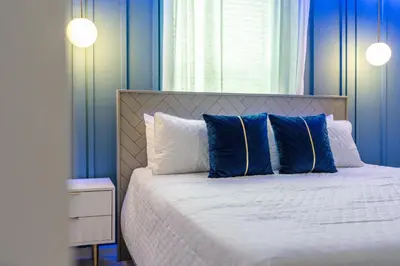 a bedroom with blue walls and a bed with blue pillows at New Home 8 Bedrooms At Bella Vida in Kissimmee