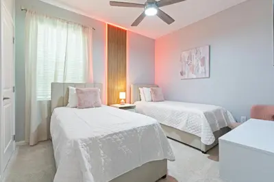 a bedroom with two beds and a ceiling fan at New Home 8 Bedrooms At Bella Vida in Kissimmee
