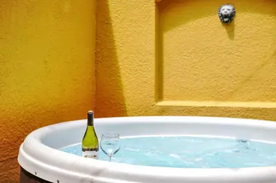 a bottle of wine and a wine glass in a bath tub at Family Oasis Cozy Retreat with Bunk Room in Kissimmee
