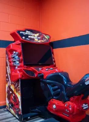 a table with a toy motorcycle and a tv on it at Casa c/ Piscina, Sala de Jogos e 6 Suítes in Orlando