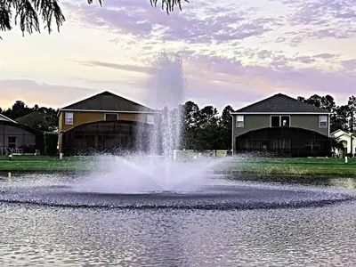 a fountain in the middle of a pond with houses at Ideal 3 BR Resort Villa with Laundry in Kissimmee