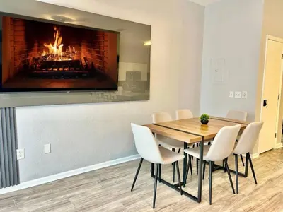 a dining room with a fireplace and a table and chairs at 7660 - 3Q/3B Casa em Resort *10min DISNEY* in Orlando