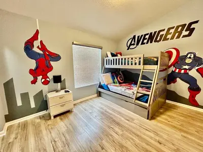 a bedroom with a superhero mural on the wall at 7660 - 3Q/3B Casa em Resort *10min DISNEY* in Orlando