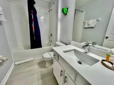 a white bathroom with a sink and a toilet at 7660 - 3Q/3B Casa em Resort *10min DISNEY* in Orlando
