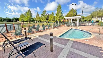 a swimming pool with lounge chairs at Deluxe Villas Resort at Seven Dwrafs - Close to Disney in Kissimmee