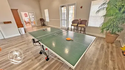 a ping pong table in the middle of a room at Deluxe Villas Resort at Seven Dwrafs - Close to Disney in Kissimmee