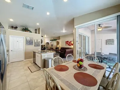 a kitchen and dining room with a table and chairs at 4 Bed in Windsor Palms Resort - Steps to Disney villa in Kissimmee