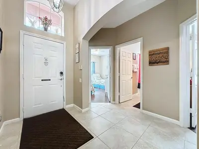 a hallway with a white door and a room with at 4 Bed in Windsor Palms Resort - Steps to Disney villa in Kissimmee