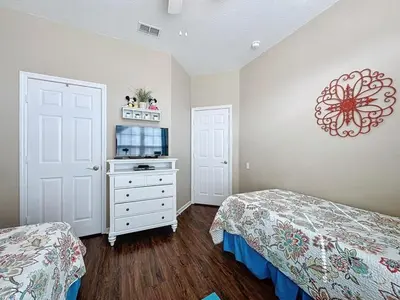 a small bedroom with two beds and a microwave at 4 Bed in Windsor Palms Resort - Steps to Disney villa in Kissimmee