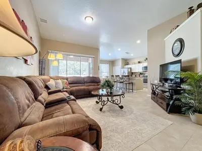 a large living room with a couch and a tv at 4 Bed in Windsor Palms Resort - Steps to Disney villa in Kissimmee