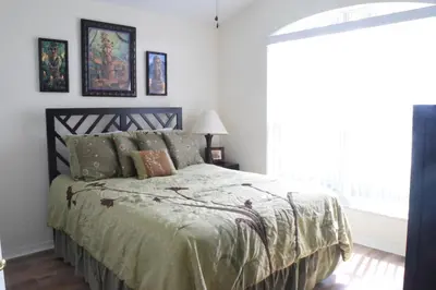 a bedroom with a bed and a window at 2551 Oneida Grantham! in Kissimmee
