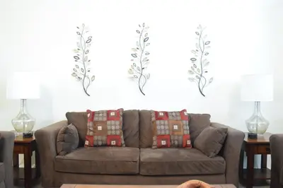 a living room with a couch and two lamps at 2551 Oneida Grantham! in Kissimmee