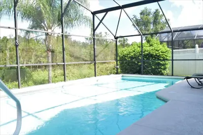 a swimming pool with a view of the trees at 2551 Oneida Grantham! in Kissimmee