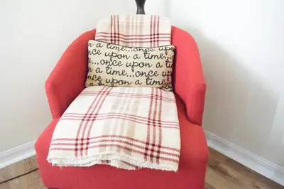 a red chair with a blanket on top of it at 2551 Oneida Grantham! in Kissimmee