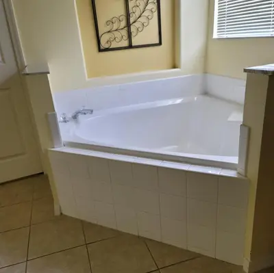 a bath tub in a bathroom with a tile floor at 8056 Indian Creek Blvd in Kissimmee