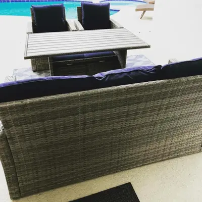 a wicker couch with two chairs and a table at 8056 Indian Creek Blvd in Kissimmee