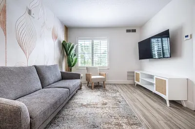 a living room with a couch and a tv at Apartment - near Epic Universe and Universal, free parking in Orlando