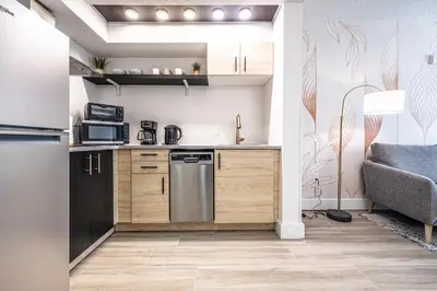 a kitchen with wooden cabinets and a refrigerator at Apartment - near Epic Universe and Universal, free parking in Orlando
