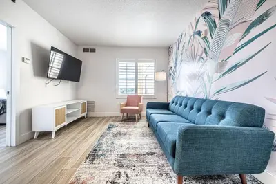 a living room with a blue couch and a chair at One bedroom unit near Epic Universe and Universal, free parking in Orlando