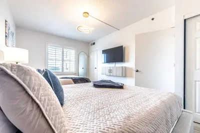 a bedroom with a bed and a flat screen tv at One bedroom unit near Epic Universe and Universal, free parking in Orlando