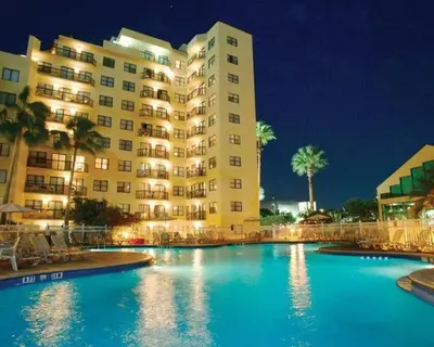 a hotel with a swimming pool in front of a building at 6165 Carrier Drive 1001 in Orlando