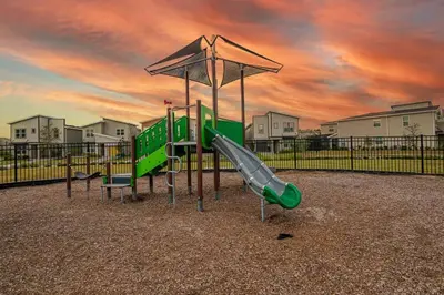 a playground with a slide and an umbrella at EPIC STYLISh retreat With Free water park near Disney in Kissimmee