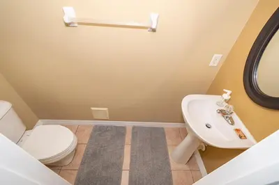 a bathroom with a white toilet and a sink at Epic Arty Retreat near Disney in Kissimmee
